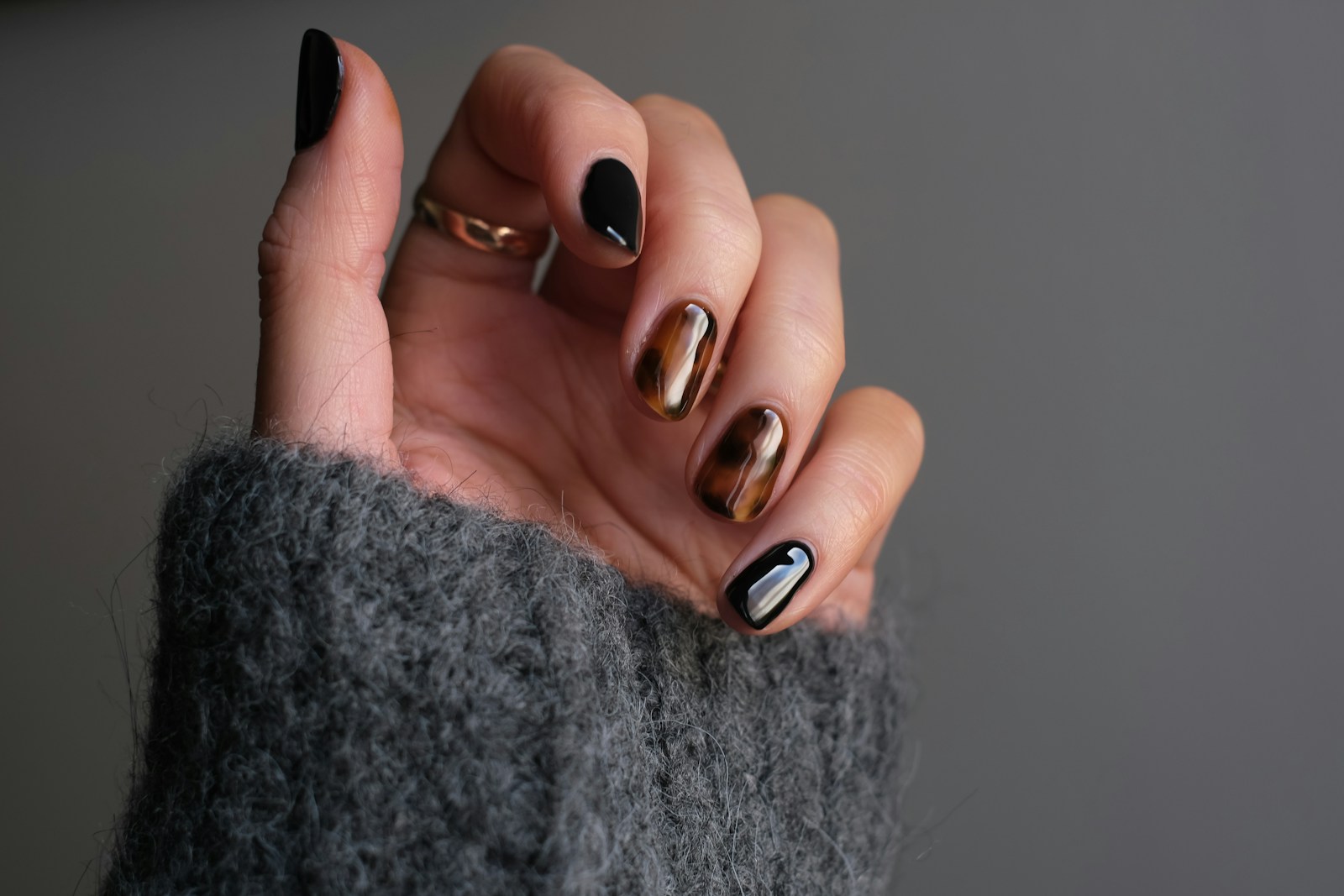 Press-on nail tips rendered on a hand